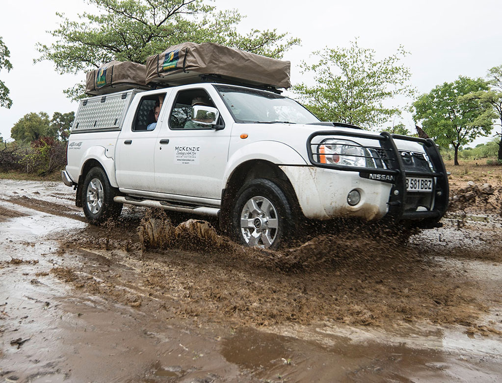 McKenzie 4x4 vehicle crossing Third Bridge in Moremi during wet season