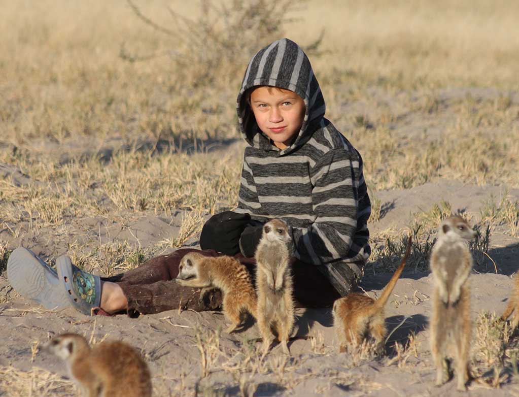 Child with meerkats at Planet Baobab